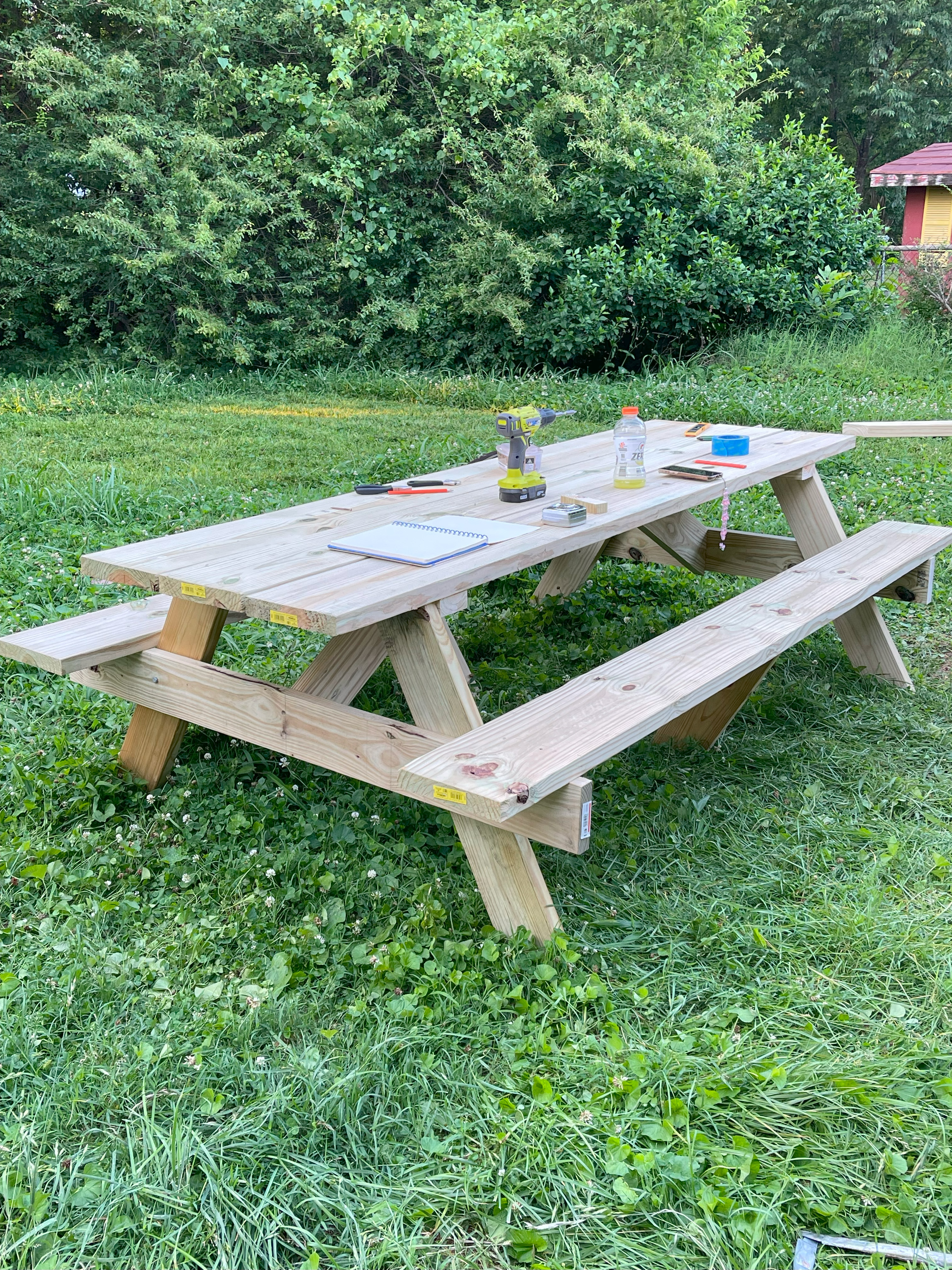 Sturdy wooden picnic table with tools sitting on top of it